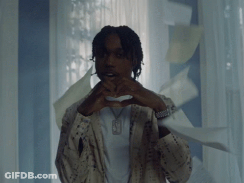 A Man Making A Heart Shape With His Hands And A Necklace With The Letter F On It GIF