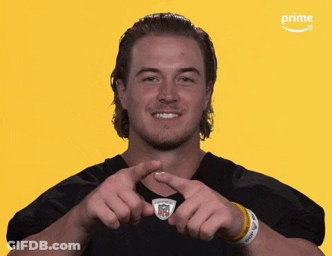 A Man Making A Heart Shape With His Hands In Front Of An Amazon Prime Logo GIF