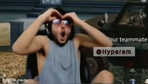 A Man Making A Heart Shape With His Hands While Wearing Sunglasses GIF
