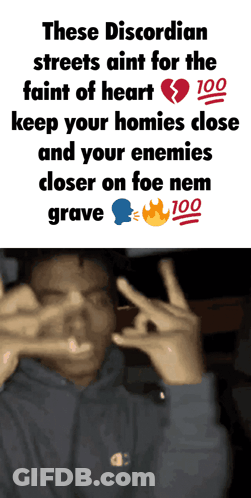 A Man Making A Peace Sign In Front Of A Sign That Says These Discordian Streets GIF