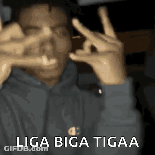 A Man Making A Peace Sign With His Hands And The Words Liga Biga Tigaa GIF