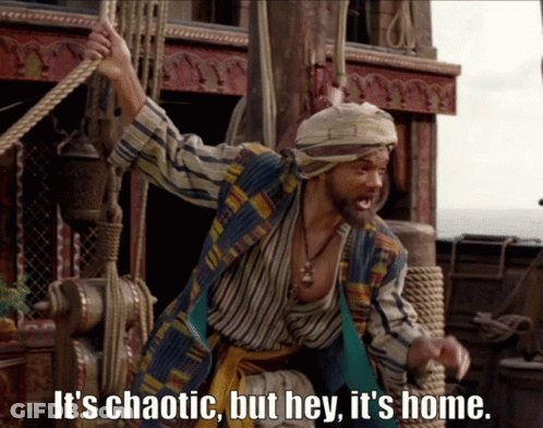 A Man On A Boat With The Words It 'S Chaotic But Hey It 'S Home Below Him GIF