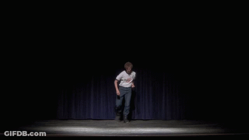 A Man On A Stage Wearing A White Shirt That Says " I Love You " On It GIF