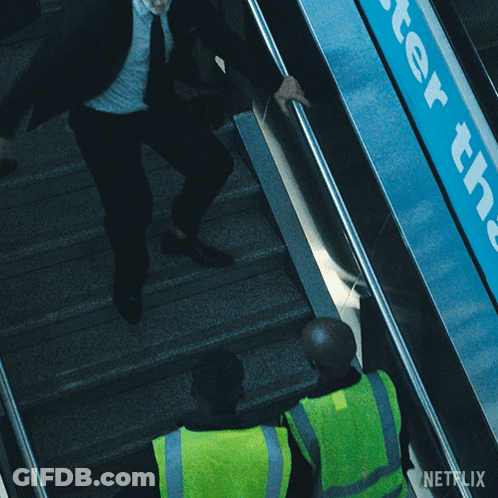 A Man On An Escalator With A Netflix Logo In The Corner GIF