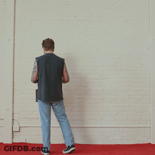 A Man Paints A Red Square On A White Wall GIF