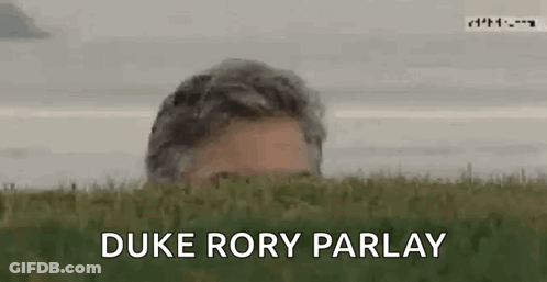 A Man Peeking Out From Behind A Grassy Hill With The Words `` Duke Rory Parlay '' Written On The Bottom . GIF