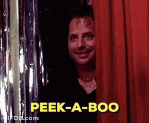 A Man Peeking Out From Behind A Red Curtain With The Words Peek-A-Boo In Yellow GIF