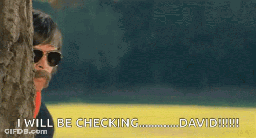 A Man Peeking Out From Behind A Tree Says I Will Be Checking David GIF