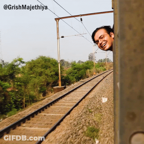 A Man Peeking Out Of A Train Window With The Caption @Grishmajethiya GIF