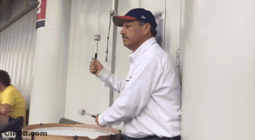 A Man Playing A Drum With A Hat That Says New Era On It GIF