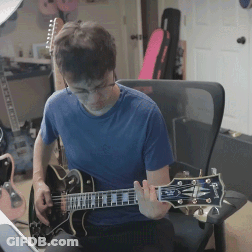 Man Playing Gibson Guitar In Chair GIF
