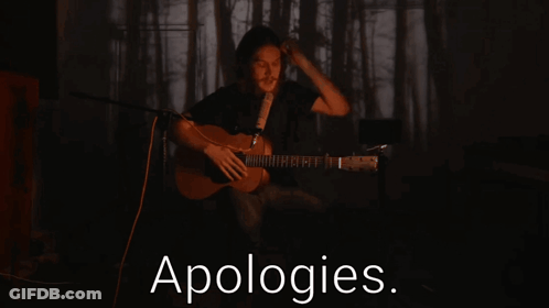Man Playing Guitar Singing Into Microphone With Apologies Text GIF