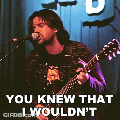 A Man Playing A Guitar And Singing Into A Microphone With The Words " You Knew That I Wouldn 'T " GIF