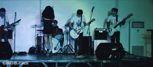 A Man Playing A Guitar Has A Sticker On His Shirt That Says Mcdonalds GIF
