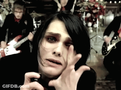 A Man Playing A Guitar In A Band With A Woman Covering Her Eyes GIF
