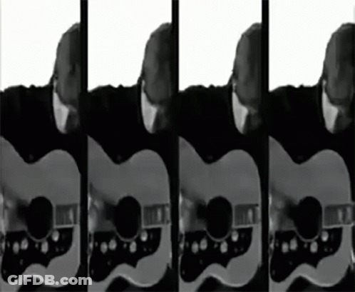 A Man Playing A Guitar In Black And White GIF