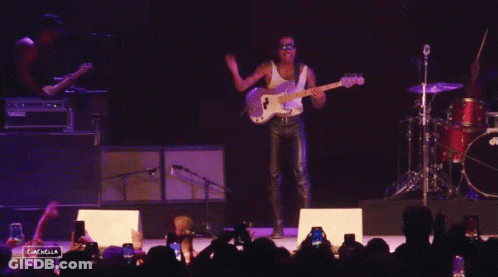A Man Playing A Guitar In Front Of A Crowd With The Words Coachella Visible GIF