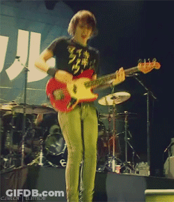 A Man Playing A Guitar On A Stage With A Cator Tumblr Watermark GIF