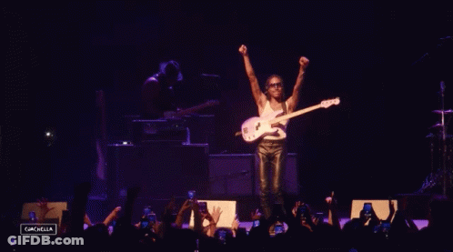 A Man Playing A Guitar On A Stage With The Name Steve Lacy GIF