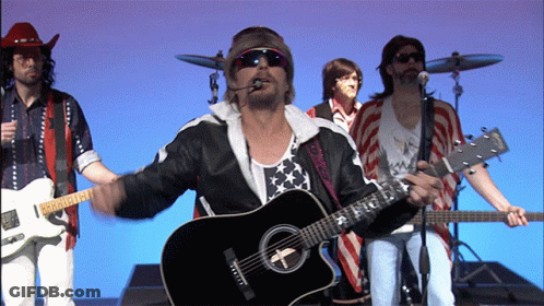 A Man Playing A Guitar That Has The Letter T On It GIF