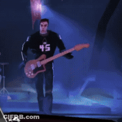 A Man Playing A Guitar With A 45 On His Shirt GIF