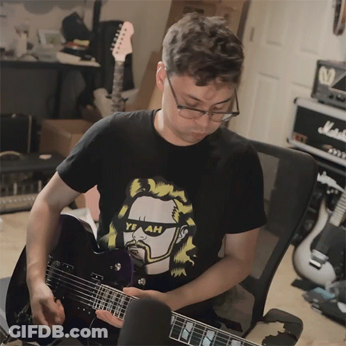 Man Playing Guitar With Yeah Shirt GIF