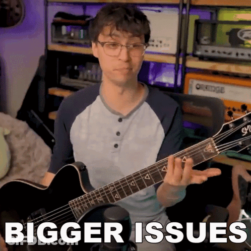 Guitar Player With Bigger Issues Behind Him GIF