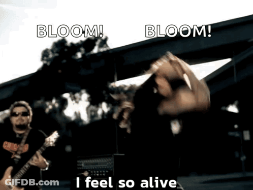 A Man Playing A Guitar With The Words Bloom I Feel So Alive GIF