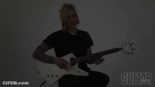 A Man Playing A Guitar With The Words Guitar World Below Him GIF