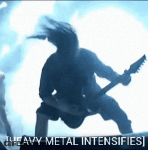 A Man Playing A Guitar With The Words Heavy Metal Intensifies GIF