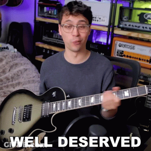 A Man Playing A Guitar With The Words Well Deserved Written Below Him GIF