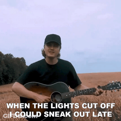 A Man Playing A Guitar With The Words When The Lights Cut Off I Could Sneak Out Late Below Him GIF