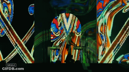 A Man Playing A Keyboard In Front Of A Colorful Screen That Says Gazelle GIF