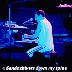 A Man Playing A Piano With The Words " Sends Shivers Down My Spine " Next To Him GIF