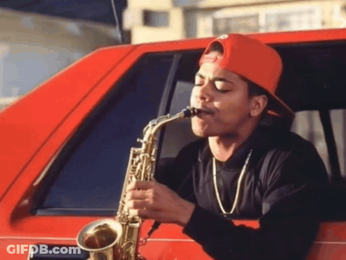 A Man Playing A Saxophone In A Red Car GIF