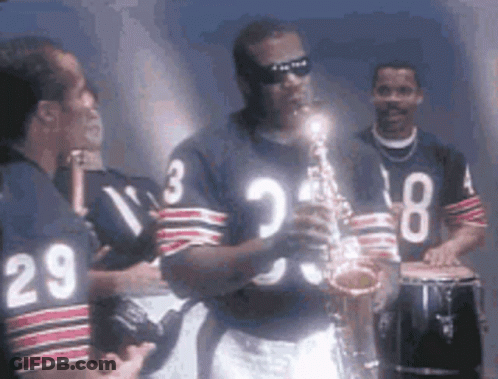 A Man Playing A Saxophone While Wearing A Jersey With The Number 29 GIF