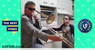 A Man Playing A Trombone In A Kitchen With The Words " The Best Vines " On The Bottom GIF