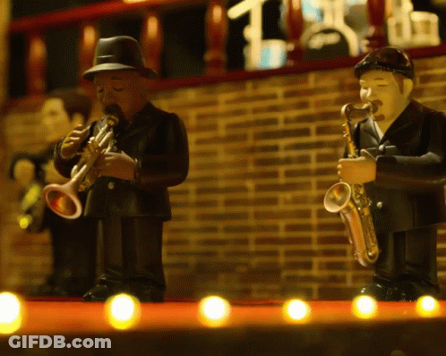 A Man Playing A Trumpet And A Man Playing A Saxophone Are On A Stage GIF