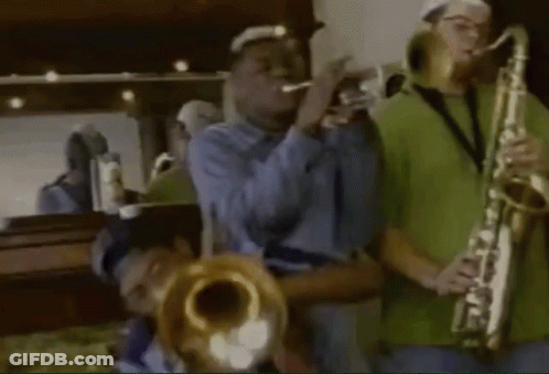 A Man Playing A Trumpet And Another Man Playing A Saxophone In Front Of A Mirror GIF