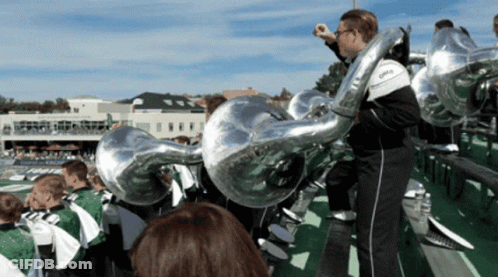 A Man Playing A Trumpet In A Marching Band With The Word Ohio On It GIF