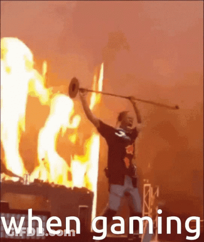 A Man Playing A Trumpet In Front Of A Fire With The Words " When Gaming " GIF