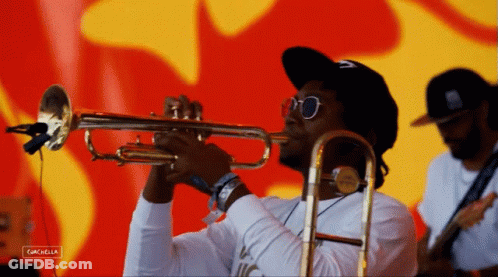A Man Playing A Trumpet In Front Of A Red And Yellow Background With The Word Cancella On The Bottom GIF