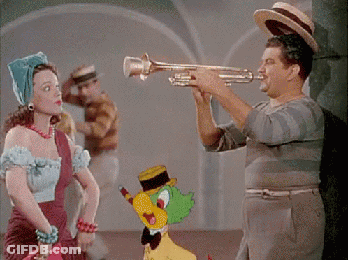A Man Playing A Trumpet Next To A Woman GIF