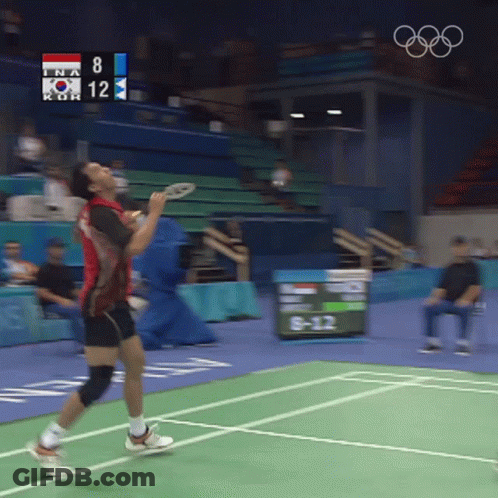 A Man Playing Badminton With A Scoreboard That Says 8 And 12 GIF