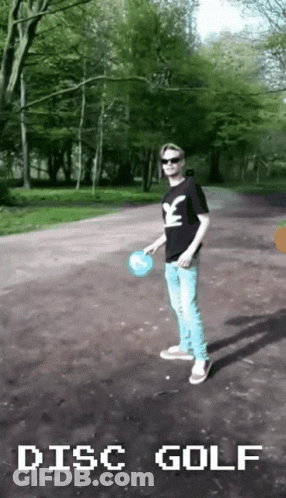 A Man Playing Disc Golf In A Park GIF