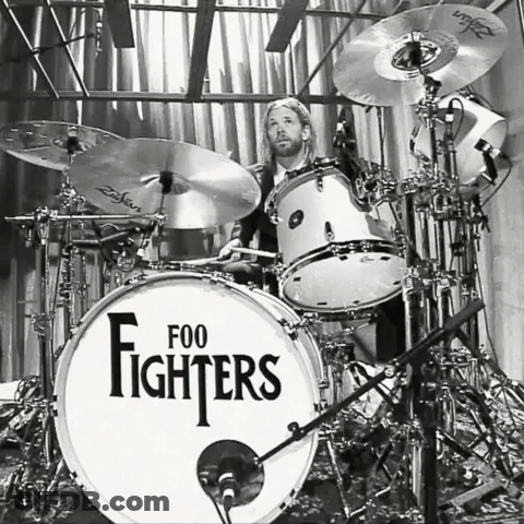 A Man Playing Drums With A Drum Set That Says Foo Fighters On It GIF