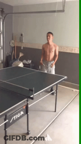 A Man Playing Ping Pong On A Stiga Table In A Garage GIF
