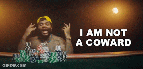 A Man Playing Poker With The Words I Am Not A Coward GIF