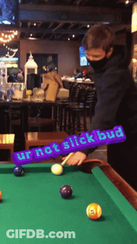 A Man Playing Pool With A Purple Sign That Says Ur Not Slick Bud GIF
