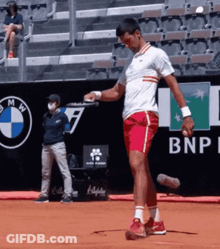 A Man Playing Tennis On A Court With A Bnp Logo In The Background GIF
